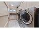 Bright laundry room with front-load washer and dryer at 5126 Fairway Oaks Dr, Windermere, FL 34786