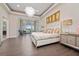 Spacious main bedroom with a king-size bed, sitting area, and hardwood floors at 5126 Fairway Oaks Dr, Windermere, FL 34786