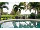 Relaxing poolside seating area with tranquil water views at 5126 Fairway Oaks Dr, Windermere, FL 34786