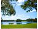 Serene lakefront view with lush landscaping and homes at 5126 Fairway Oaks Dr, Windermere, FL 34786