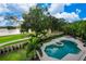 Elevated view of a large pool, spa, and patio overlooking a golf course at 5126 Fairway Oaks Dr, Windermere, FL 34786