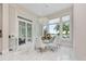 Bright breakfast nook with glass table, white chairs, and scenic views at 5126 Fairway Oaks Dr, Windermere, FL 34786