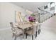 Elegant dining room with large table, statement art, and modern chandelier at 5126 Fairway Oaks Dr, Windermere, FL 34786