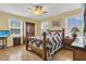 Cozy bedroom with a wooden bed frame and large windows at 3105 Pastures Rd, Kissimmee, FL 34746