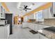 Modern kitchen with white cabinets, granite countertops, and stainless steel appliances at 3105 Pastures Rd, Kissimmee, FL 34746