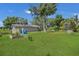 Large backyard with garden, shed, and solar panels at 3105 Pastures Rd, Kissimmee, FL 34746