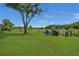 Landscaped backyard with trees and irrigation system at 3105 Pastures Rd, Kissimmee, FL 34746