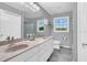 Double vanity bathroom with updated fixtures and a large mirror at 3105 Pastures Rd, Kissimmee, FL 34746