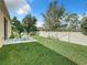 Fenced backyard with patio and green lawn at 1880 Monte Cristo Ln, Kissimmee, FL 34758