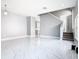 Bright living room with marble floors and a view of the staircase at 133 Andalusia Loop, Davenport, FL 33837
