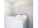 Laundry room with washer, dryer, and overhead shelving at 133 Andalusia Loop, Davenport, FL 33837