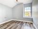 Charming bedroom with a large window, wood-look floors and ceiling fan at 133 Andalusia Loop, Davenport, FL 33837