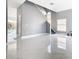 Bright living room with gray walls, white marble floor, and staircase at 133 Andalusia Loop, Davenport, FL 33837