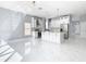 Modern kitchen with white cabinets, marble countertops, and stainless steel appliances at 133 Andalusia Loop, Davenport, FL 33837