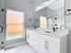Bathroom with double vanity and marble countertops at 133 Andalusia Loop, Davenport, FL 33837