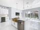 Modern kitchen with island, stainless steel appliances and pool view at 133 Andalusia Loop, Davenport, FL 33837