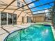 Inviting screened pool and spa with a large patio at 133 Andalusia Loop, Davenport, FL 33837