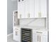White cabinets and marble countertop in this kitchen at 133 Andalusia Loop, Davenport, FL 33837