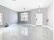 Spacious living room featuring marble floors and a large window at 133 Andalusia Loop, Davenport, FL 33837