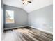 Bright bedroom with window, wood-look floors and ceiling fan at 133 Andalusia Loop, Davenport, FL 33837