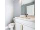Modern bathroom with white cabinets, marble countertops, and gold accents at 133 Andalusia Loop, Davenport, FL 33837