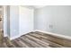 Bright bedroom featuring wood-look floors and double door closet at 133 Andalusia Loop, Davenport, FL 33837