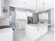 Elegant kitchen boasting white cabinets, marble countertops, and a large island at 133 Andalusia Loop, Davenport, FL 33837