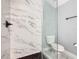 Bathroom with a large marble shower and hexagon tile floor at 133 Andalusia Loop, Davenport, FL 33837