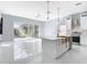 Kitchen with island, pool view, and marble flooring at 133 Andalusia Loop, Davenport, FL 33837