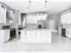 Modern kitchen with white cabinets, marble counters, and gold accents at 133 Andalusia Loop, Davenport, FL 33837