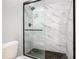 Large walk-in shower with marble tile and glass enclosure at 133 Andalusia Loop, Davenport, FL 33837