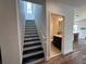 Modern staircase with black and white risers leading to the upper level at 4812 Marcos Cir, Kissimmee, FL 34758