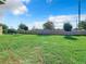 Large backyard with grassy lawn and a privacy fence at 4812 Marcos Cir, Kissimmee, FL 34758