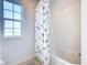 Simple bathroom with a shower/tub combo and an arrow-patterned shower curtain at 4812 Marcos Cir, Kissimmee, FL 34758