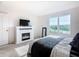 Relaxing bedroom with fireplace, large window and comfortable bed at 4812 Marcos Cir, Kissimmee, FL 34758