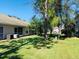 Spacious backyard with lush lawn and mature trees at 2181 Cypress Bay Blvd, Kissimmee, FL 34743