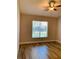 Bedroom with hardwood floors and large window at 2181 Cypress Bay Blvd, Kissimmee, FL 34743