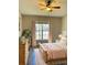 Bright bedroom with wood flooring, large window, and ceiling fan at 2181 Cypress Bay Blvd, Kissimmee, FL 34743