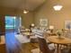 Open living and dining area with hardwood floors and neutral decor at 2181 Cypress Bay Blvd, Kissimmee, FL 34743