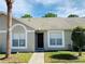 Front view of charming condo with mature landscaping at 2181 Cypress Bay Blvd, Kissimmee, FL 34743