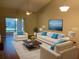 Living room with vaulted ceiling, hardwood floors, and comfy seating at 2181 Cypress Bay Blvd, Kissimmee, FL 34743