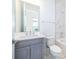 Bathroom with tub, toilet and gray vanity at 9752 Laurel Berry Dr, Orlando, FL 32827