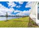 Lakefront backyard with grassy area and paver patio at 9752 Laurel Berry Dr, Orlando, FL 32827