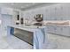 Modern kitchen with white cabinets, marble countertops, and high-end appliances at 9752 Laurel Berry Dr, Orlando, FL 32827