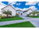 Two-story home with white exterior, palm trees, and a paved driveway at 9752 Laurel Berry Dr, Orlando, FL 32827