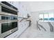 Modern kitchen with stainless steel appliances and marble backsplash at 9752 Laurel Berry Dr, Orlando, FL 32827