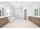 Spa-like bathroom with soaking tub, walk-in shower, and dual vanities at 9752 Laurel Berry Dr, Orlando, FL 32827