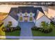 Aerial view of a home with a modern farmhouse design, near a lake at 9752 Laurel Berry Dr, Orlando, FL 32827