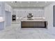Modern kitchen with white cabinets, marble countertops, and high-end appliances at 9752 Laurel Berry Dr, Orlando, FL 32827