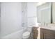 Bathroom with tub, toilet and gray vanity at 9752 Laurel Berry Dr, Orlando, FL 32827